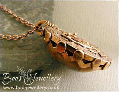 Faux amber cabochon set in a pink bronze bezel pendant