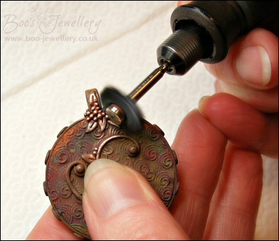 Faux amber cabochon set in a pink bronze bezel pendant