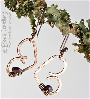 Antiqued copper heart earrings wrapped with garnet chips