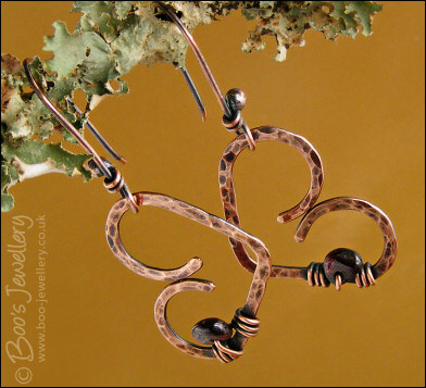 Antiqued copper heart earrings wrapped with garnet chips