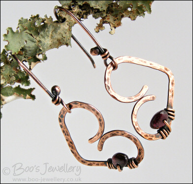 Antiqued copper heart earrings wrapped with garnet chips