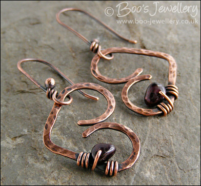 Antiqued copper heart earrings wrapped with garnet chips
