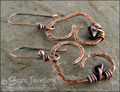 Antiqued copper heart earrings wrapped with garnet chips