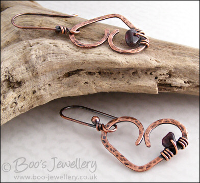 Antiqued copper heart earrings wrapped with garnet chips