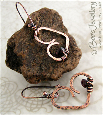 Antiqued copper heart earrings wrapped with garnet chips