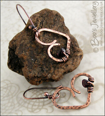 Antiqued copper heart earrings wrapped with garnet chips