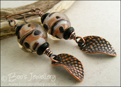 Spotted glass bead and copper charm earrings