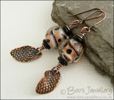 Spotted glass bead and copper charm earrings