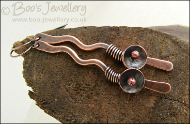 Antiqued copper squiggle earrings with a bud and flower