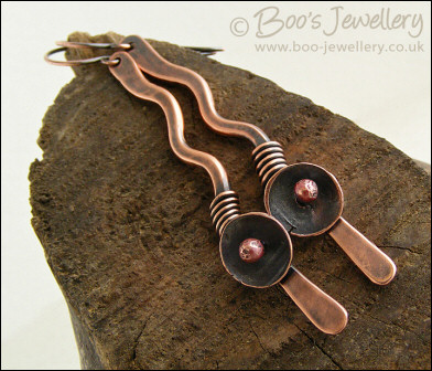 Antiqued copper squiggle earrings with a bud and flower