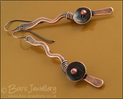 Antiqued copper squiggle earrings with a bud and flower