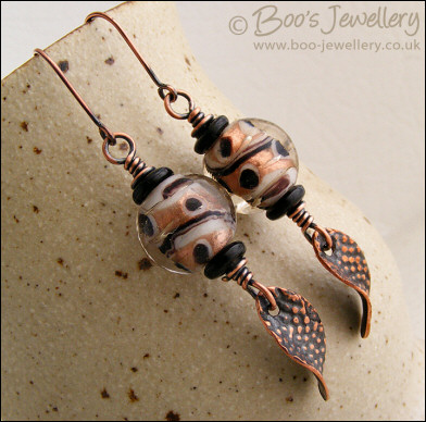 Spotted glass bead and copper charm earrings