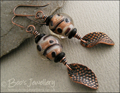 Spotted glass bead and copper charm earrings