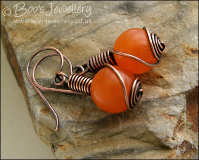 Antiqued copper and orange jade rosebud knot earrings