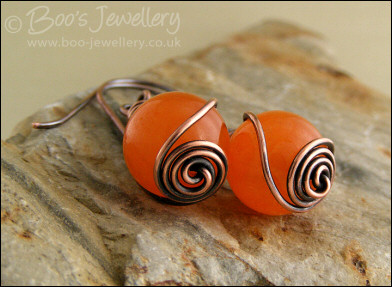 Antiqued copper and orange jade rosebud knot earrings