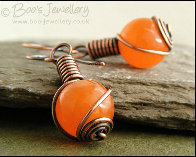 Antiqued copper and orange jade rosebud knot earrings