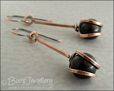 RESERVED - Antiqued copper loop capture earrings