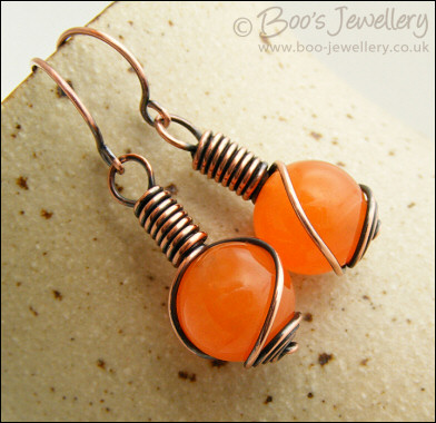 Antiqued copper and orange jade rosebud knot earrings