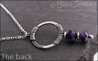 Silver circle pendant wrapped with faceted amethyst rondelles