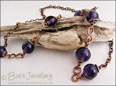 Purple glass bead necklace with copper hammered figure of 8 links
