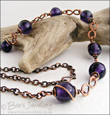 Purple glass bead necklace with copper hammered figure of 8 links