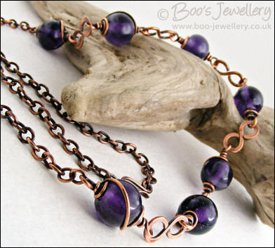 Purple glass bead necklace with copper hammered figure of 8 links