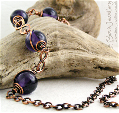 Purple glass bead necklace with copper hammered figure of 8 links
