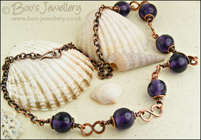 Purple glass bead necklace with copper hammered figure of 8 links