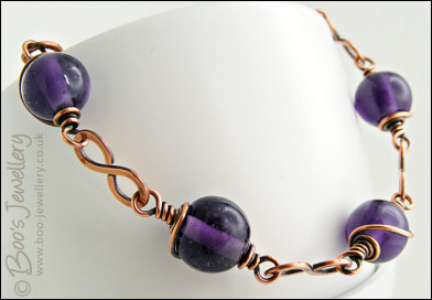 Purple glass bead necklace with copper hammered figure of 8 links