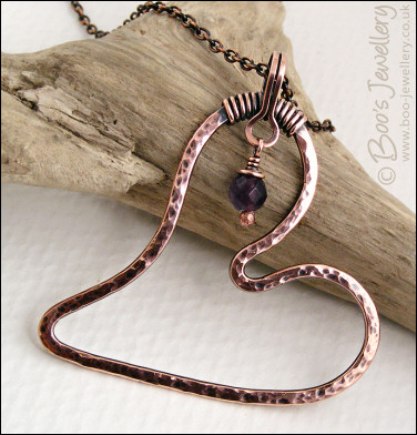 Copper heart pendant with faceted rainbow fluorite stone