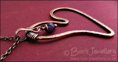 Copper heart pendant with faceted rainbow fluorite stone
