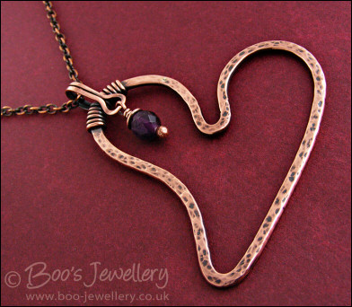 Copper heart pendant with faceted rainbow fluorite stone