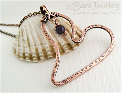Copper heart pendant with faceted rainbow fluorite stone