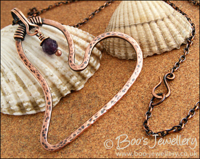 Copper heart pendant with faceted rainbow fluorite stone