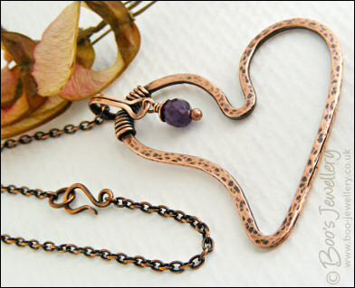 Copper heart pendant with faceted rainbow fluorite stone