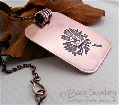 Etched daisy pendant in antiqued copper