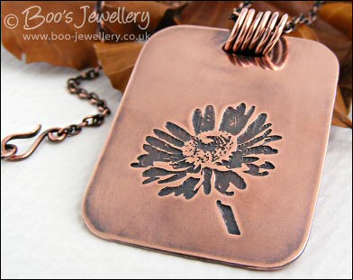 Etched daisy pendant in antiqued copper