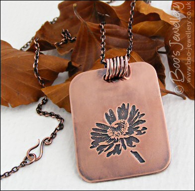 Etched daisy pendant in antiqued copper