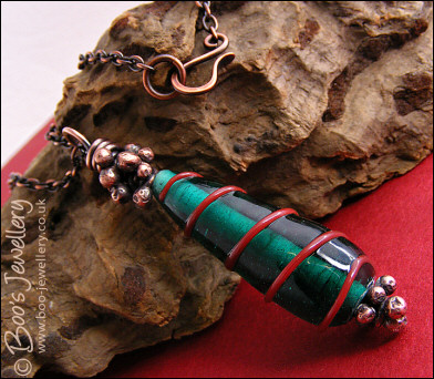 Antiqued copper and green glass pendant