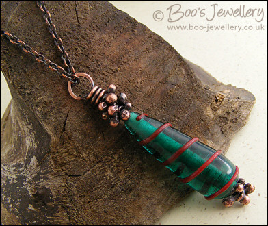 Antiqued copper and green glass pendant