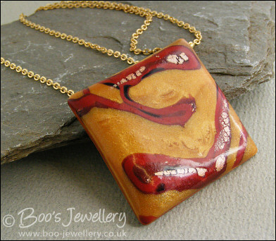 Polymer clay gold and red square pendant