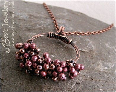 Antiqued copper circle pendant with molten copper buds