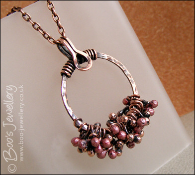 Antiqued copper circle pendant with molten copper buds