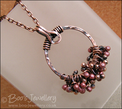 Antiqued copper circle pendant with molten copper buds