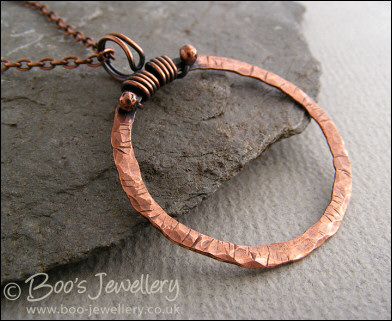 Distressed texture copper circle pendant with tendril bail