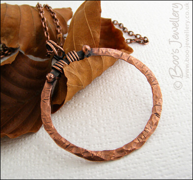Distressed texture copper circle pendant with tendril bail