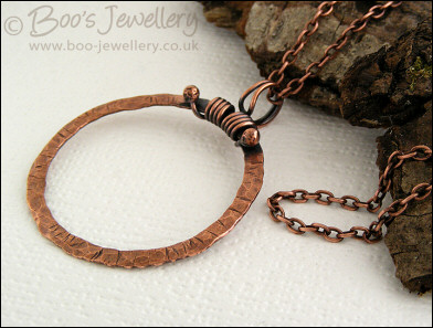 Distressed texture copper circle pendant with tendril bail
