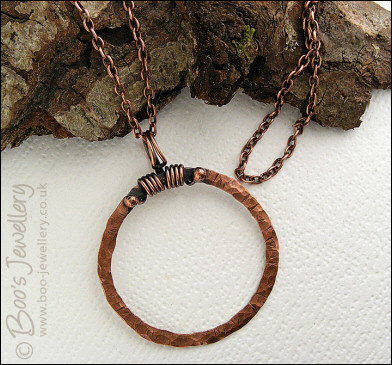 Distressed texture copper circle pendant with tendril bail