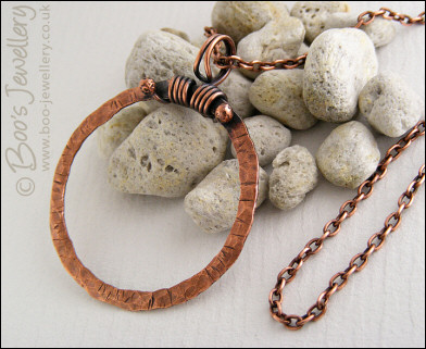 Distressed texture copper circle pendant with tendril bail