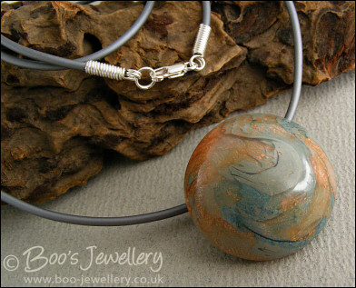 Polymer clay dome shaped pendant on PVC thong necklace